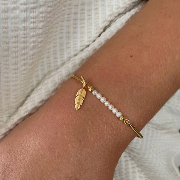 Bangle with pearls top and mini feather charm